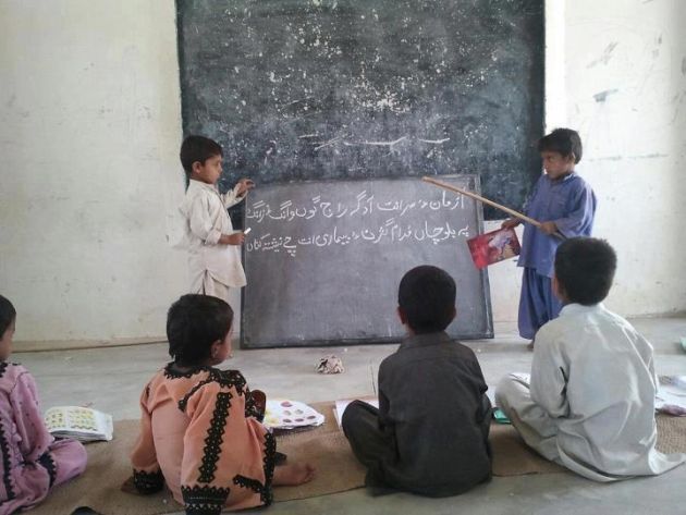 Children reading and writing Balochi